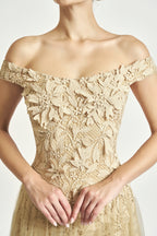 Woman wearing ROSANOR Nude Sonata off-shoulder lace midi dress, champagne tone
